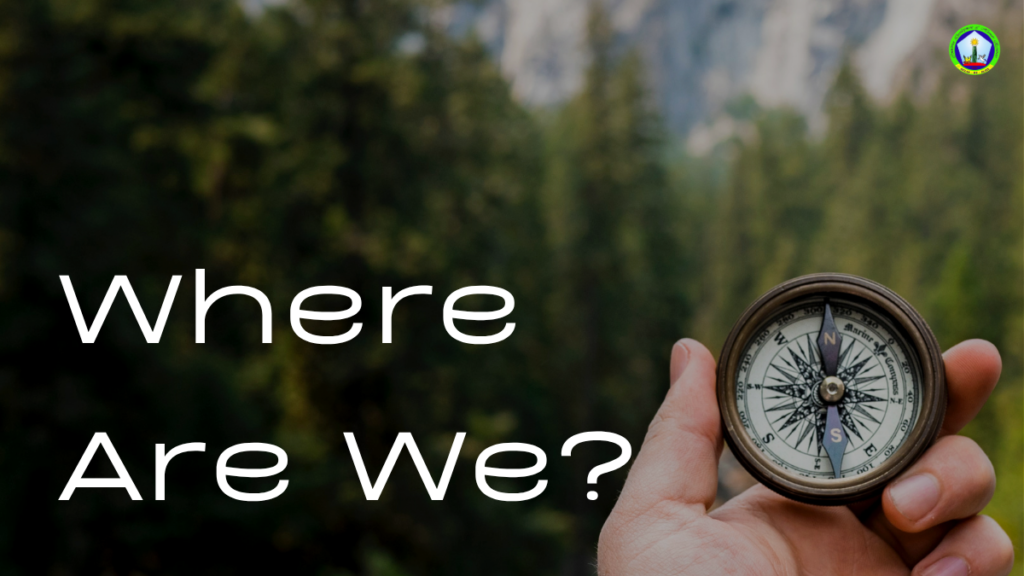 A hand holding a compass in nature